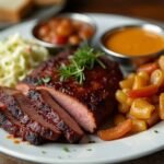 How to Make Smoky, Tender Chipotle Brisket at Home 9 Tender Chipotle Plated sliced chipotle brisket with coleslaw, cornbread, and baked beans.