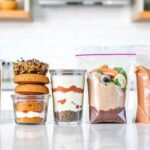 Healthy meal prep breakfast recipes for the week displayed in organized glass containers